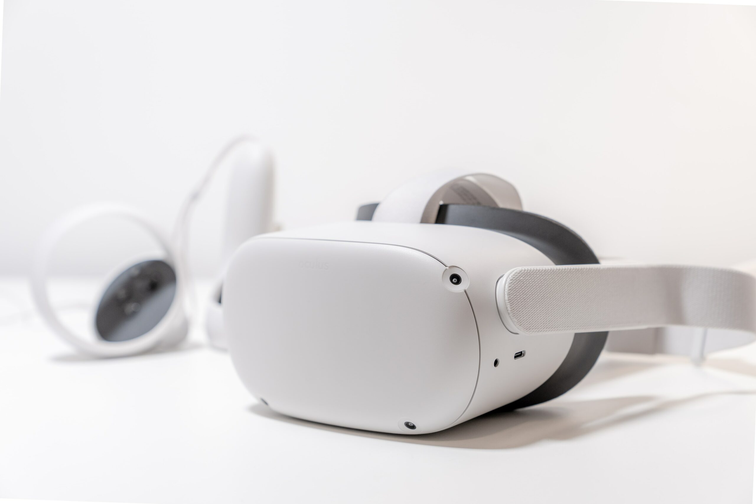 White Virtual Reality Oculus headset on white table