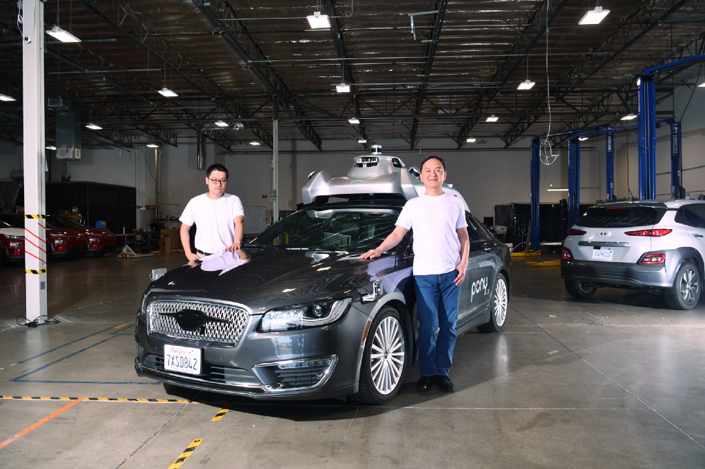 Founders James Peng and Lou Tiancheng with one of their Pony.ai vehicles at the California headquarters